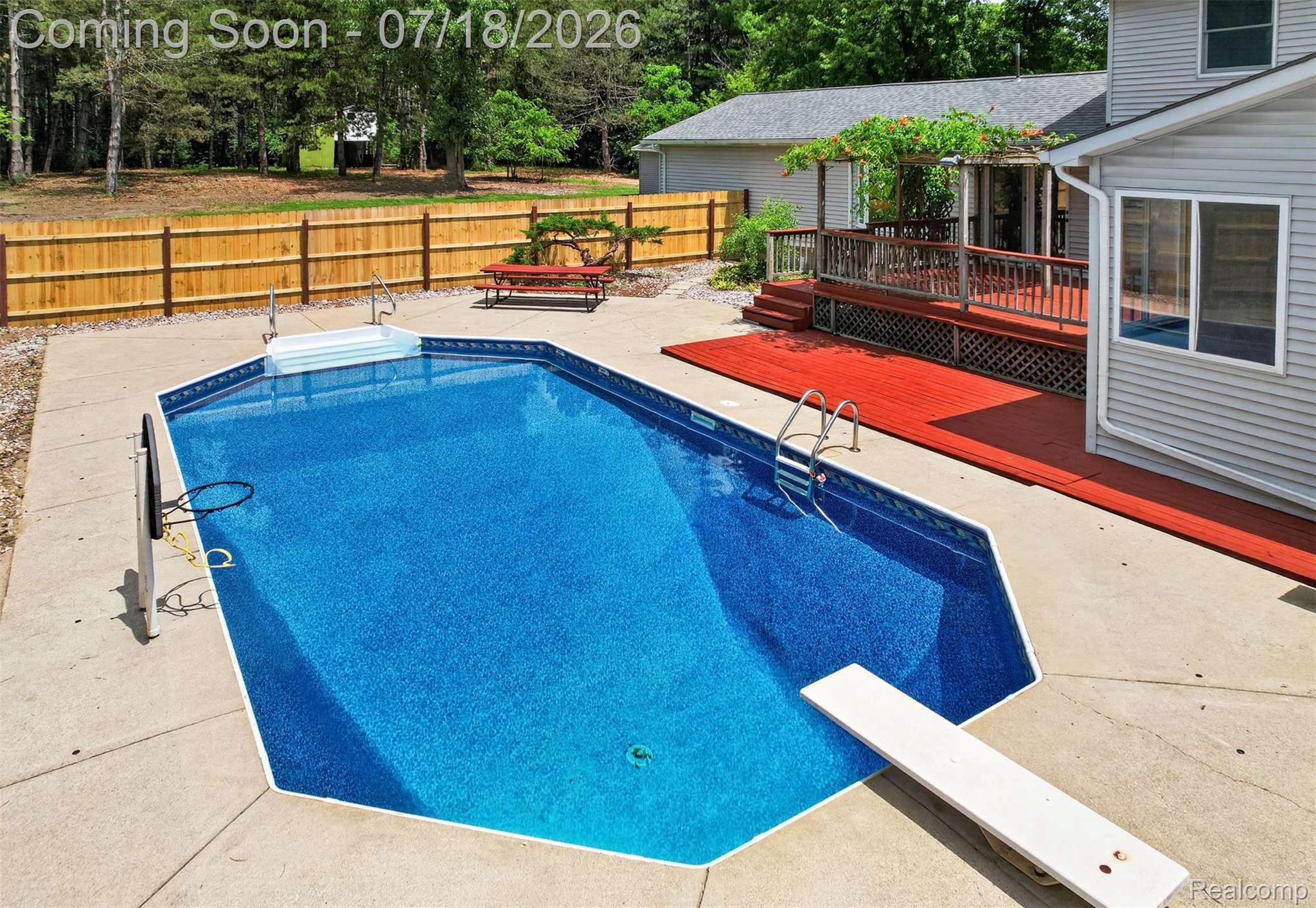 1437 East Cook Road Grand Blanc, MI 48439 - Photo 13 of 69 In-ground swimming pool featuring a diving board and concrete surround