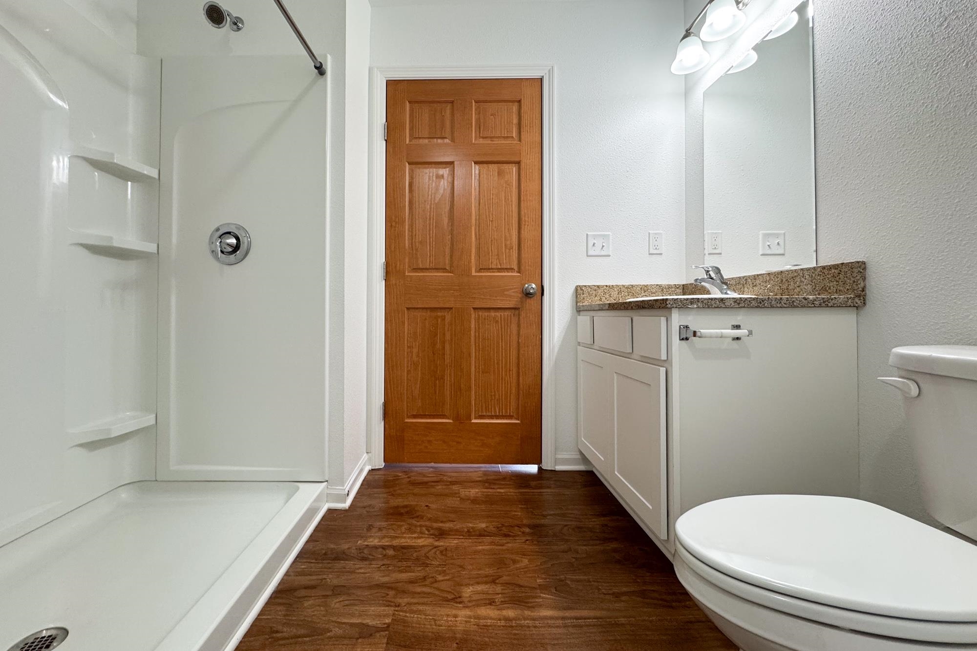 3030 Hiddengreen Drive Belvidere, IL 61008 - Photo 11 of 24 a bathroom with a granite countertop toilet a sink and mirror