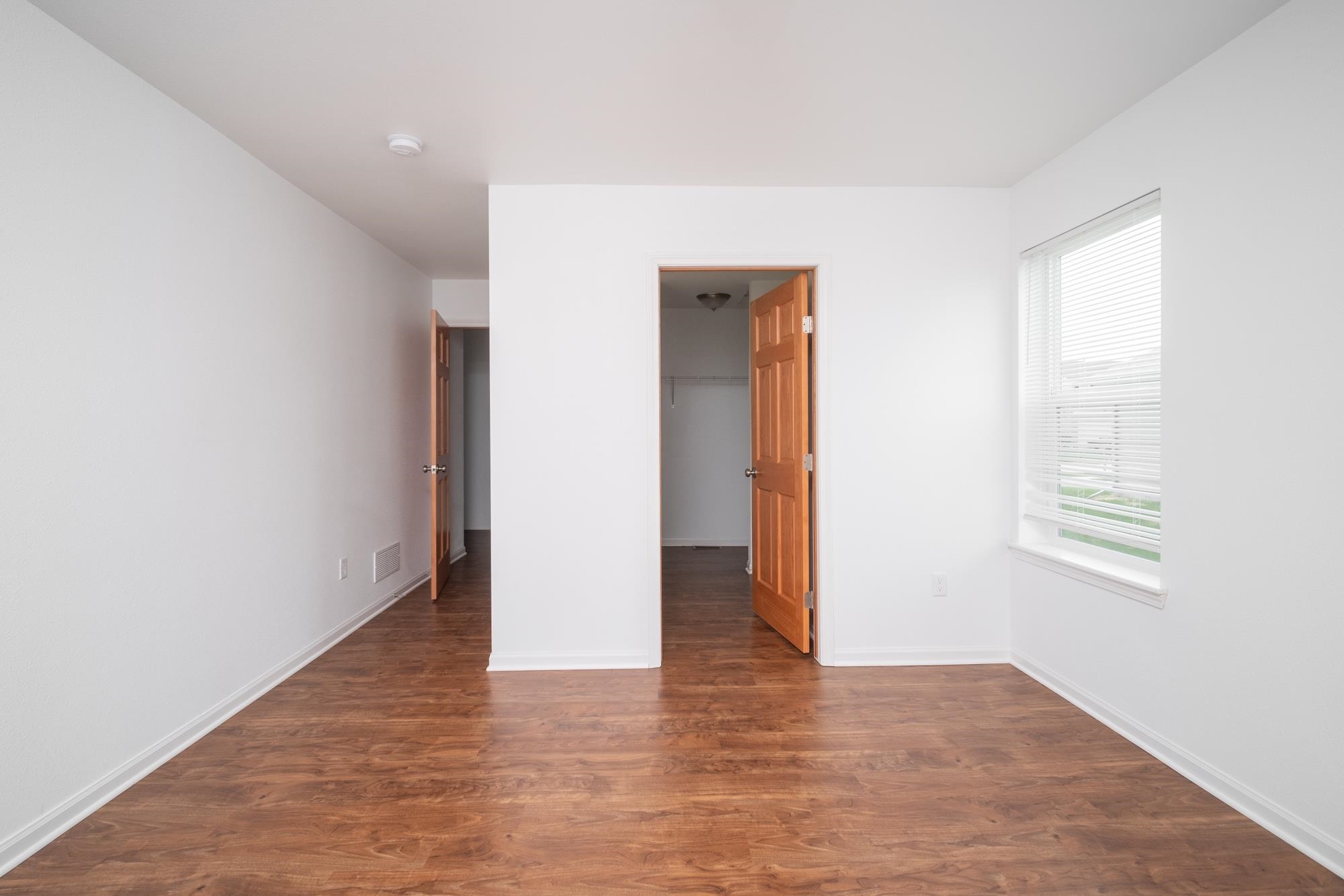 3030 Hiddengreen Drive Belvidere, IL 61008 - Photo 14 of 24 a view of an empty room with wooden floor and a window