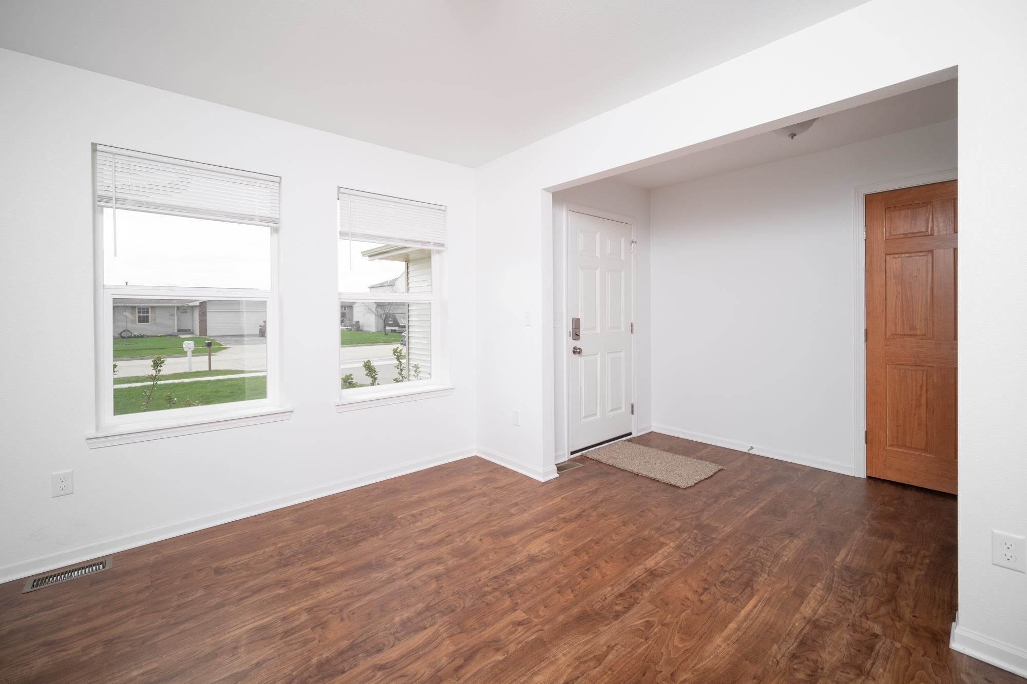 3030 Hiddengreen Drive Belvidere, IL 61008 - Photo 2 of 24 a view of an empty room with wooden floor and a window