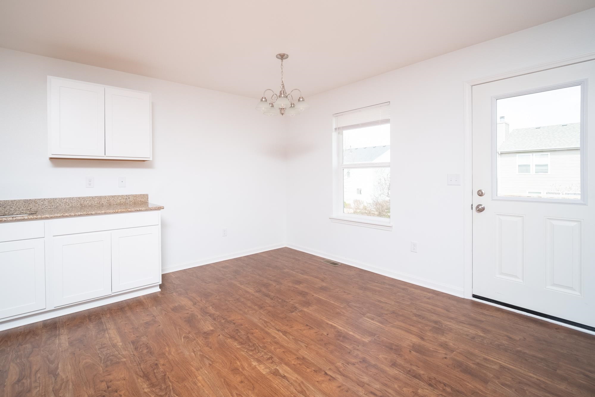 3030 Hiddengreen Drive Belvidere, IL 61008 - Photo 7 of 24 a view of empty room with wooden floor and fan