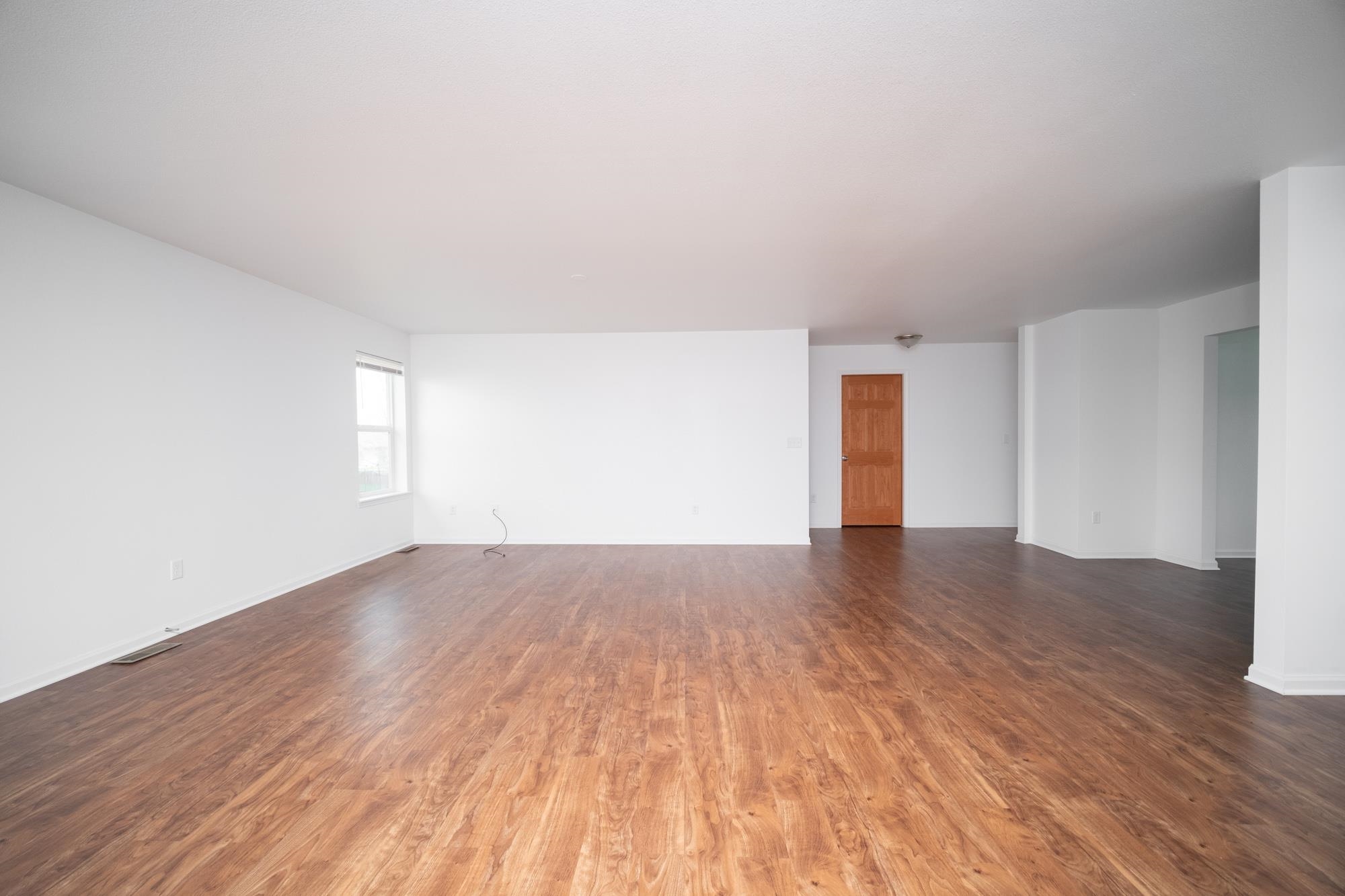 3030 Hiddengreen Drive Belvidere, IL 61008 - Photo 8 of 24 a view of an empty room with wooden floor and window