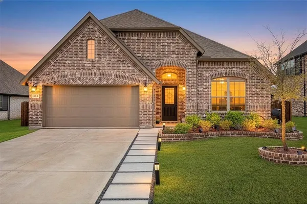a front view of house with yard and green space