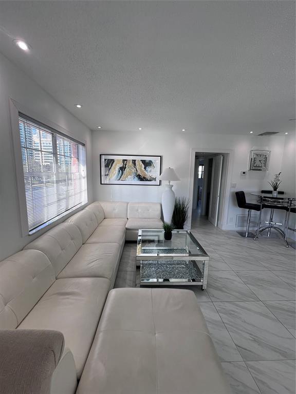 601 Southeast 5th Court, Unit 301 Fort Lauderdale, FL 33301 - Photo 1 of 28 a living room with furniture and a table