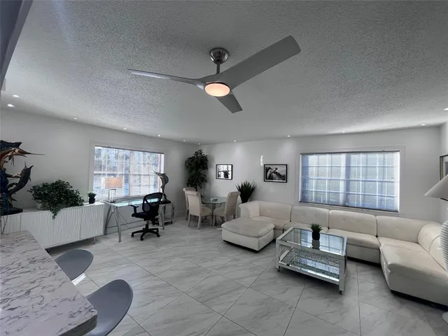 a living room with furniture and windows