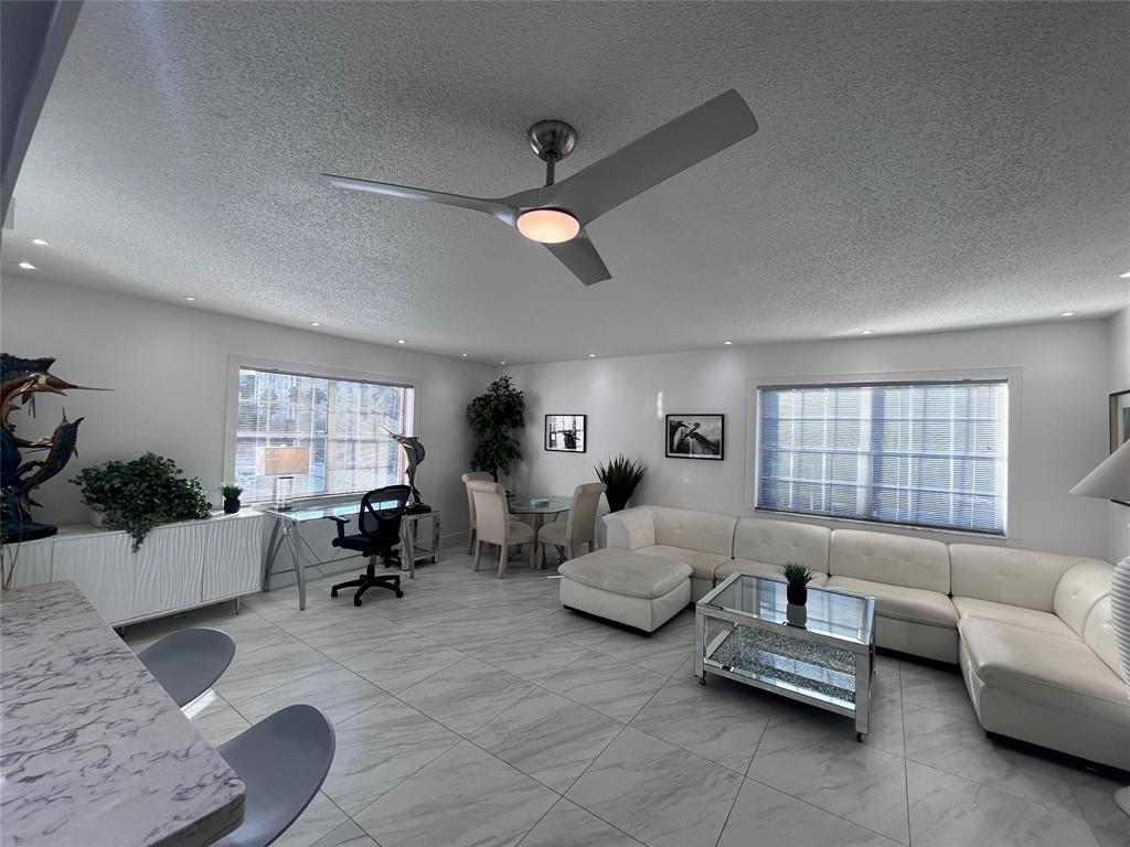 601 Southeast 5th Court, Unit 301 Fort Lauderdale, FL 33301 - Photo 14 of 28 a living room with furniture and windows