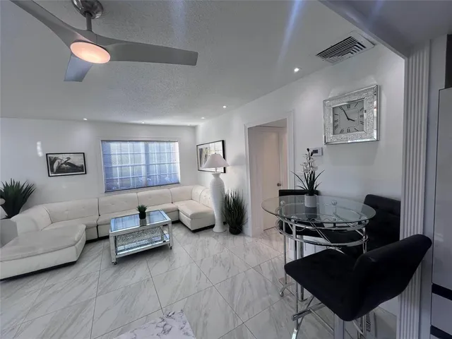 a living room with furniture rug and window