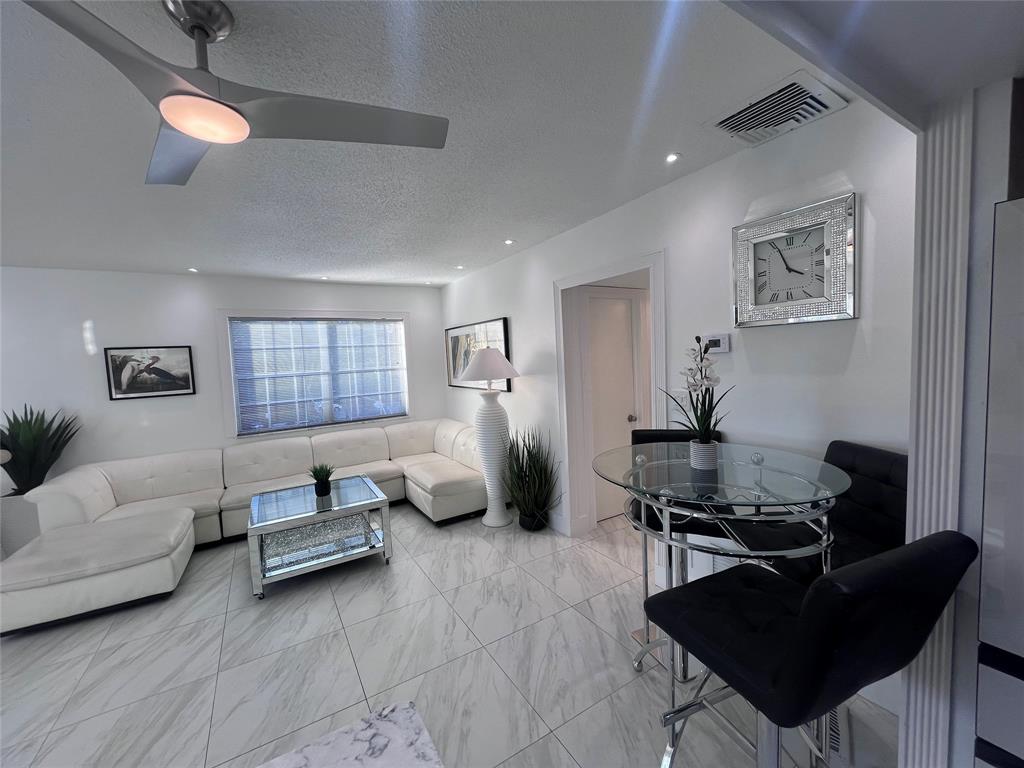 601 Southeast 5th Court, Unit 301 Fort Lauderdale, FL 33301 - Photo 15 of 28 a living room with furniture rug and window
