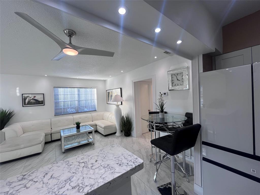 601 Southeast 5th Court, Unit 301 Fort Lauderdale, FL 33301 - Photo 16 of 28 a living room with furniture and a lamp