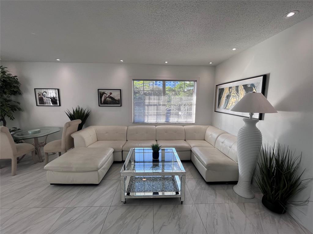 601 Southeast 5th Court, Unit 301 Fort Lauderdale, FL 33301 - Photo 2 of 28 a living room with furniture and a window