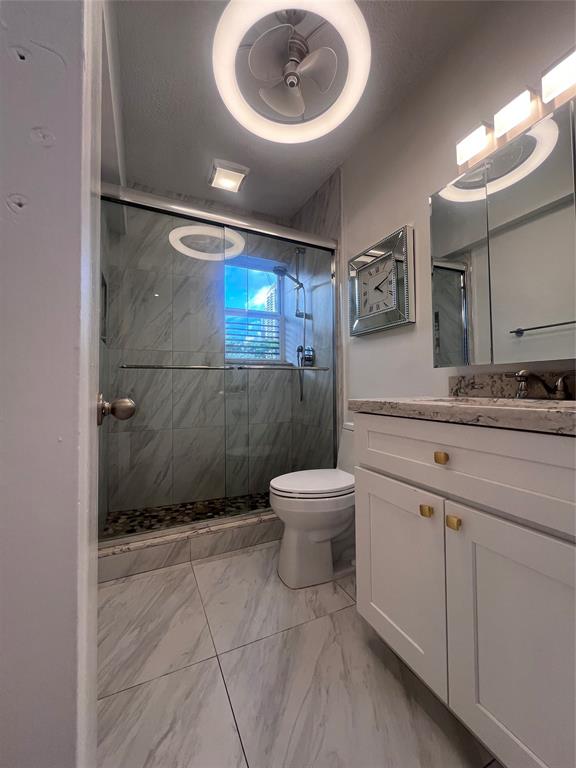601 Southeast 5th Court, Unit 301 Fort Lauderdale, FL 33301 - Photo 22 of 28 a bathroom with a sink a toilet and a mirror