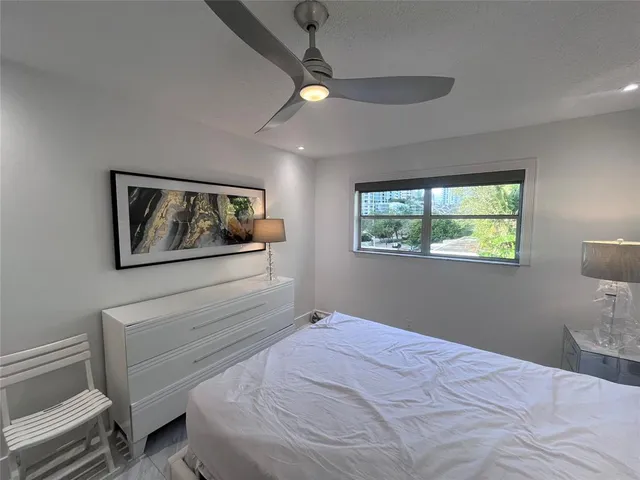 a bedroom with a bed and a lamp