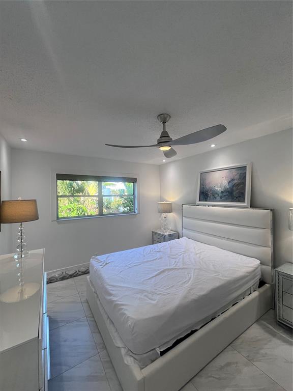 601 Southeast 5th Court, Unit 301 Fort Lauderdale, FL 33301 - Photo 24 of 28 a bedroom with a bed and a lamp