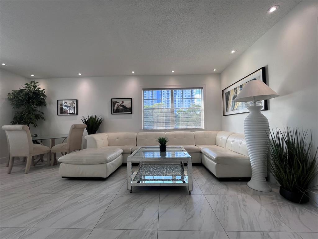 601 Southeast 5th Court, Unit 301 Fort Lauderdale, FL 33301 - Photo 3 of 28 a living room with furniture and a large window