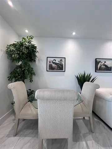 a living room with furniture flowerpot and a potted plant