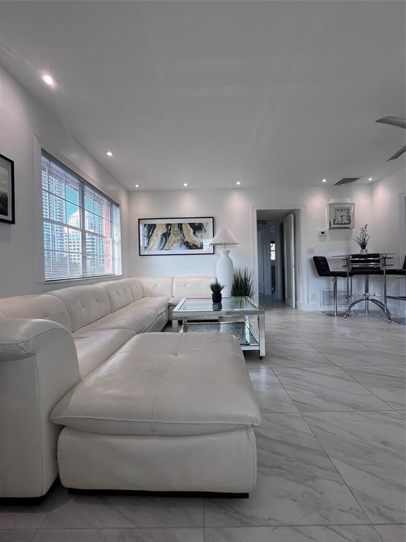 601 Southeast 5th Court, Unit 301 Fort Lauderdale, FL 33301 - Photo 5 of 28 a living room with furniture and a table