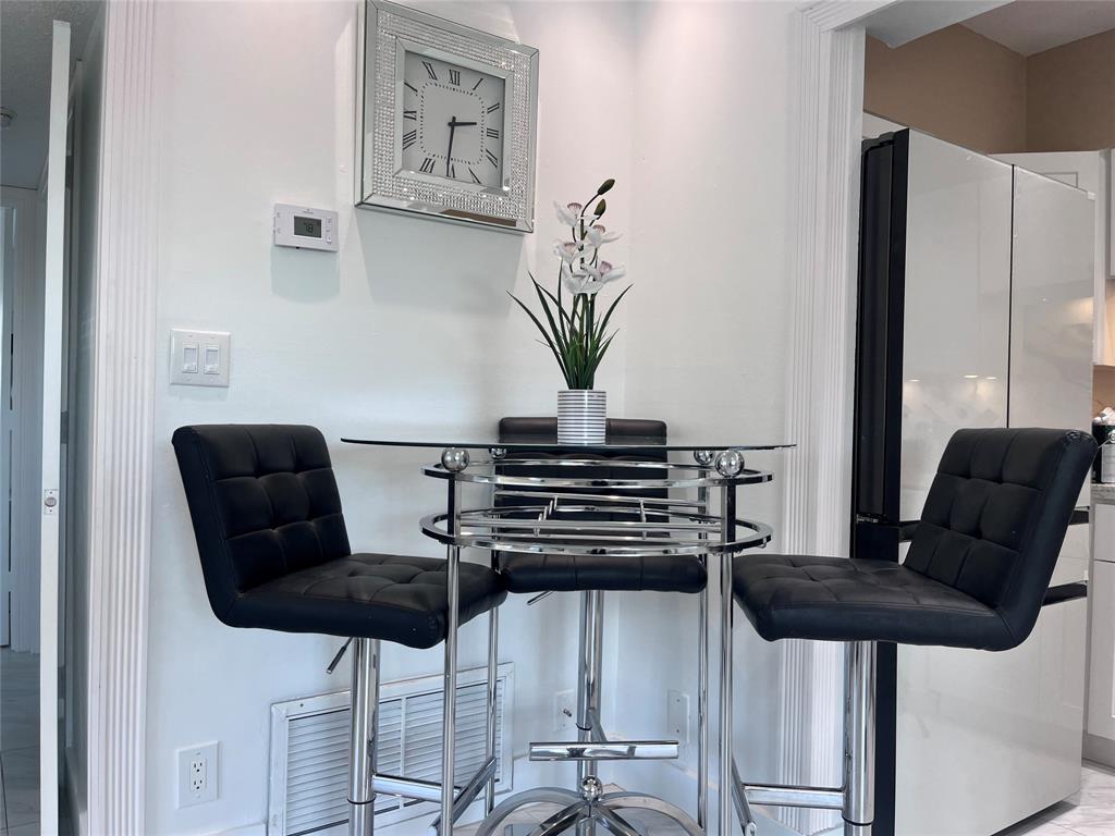 601 Southeast 5th Court, Unit 301 Fort Lauderdale, FL 33301 - Photo 7 of 28 a view of a dining room with furniture and wooden floor
