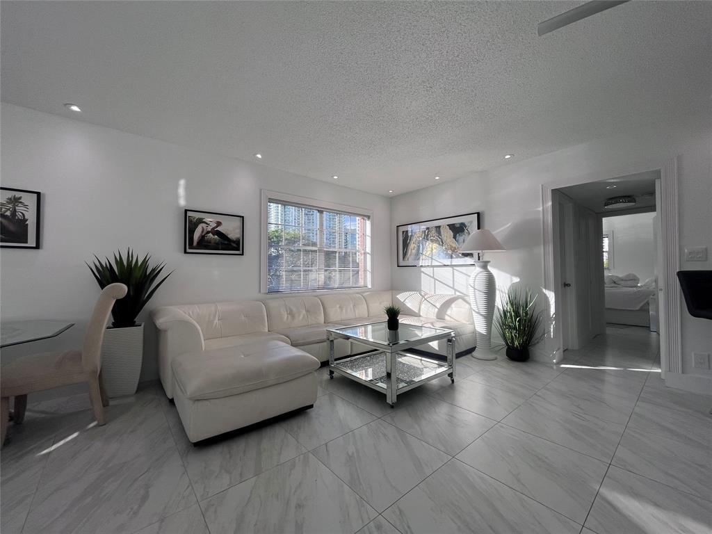 601 Southeast 5th Court, Unit 301 Fort Lauderdale, FL 33301 - Photo 8 of 28 a living room with furniture and a potted plant