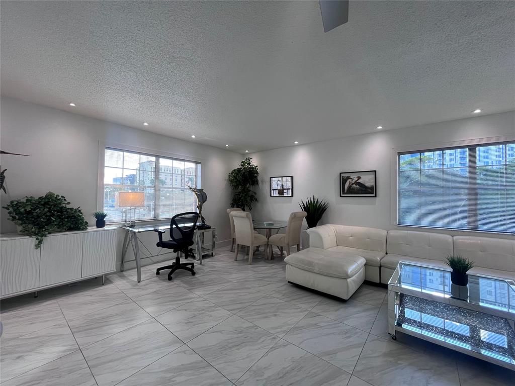 601 Southeast 5th Court, Unit 301 Fort Lauderdale, FL 33301 - Photo 9 of 28 a living room with furniture and a large window