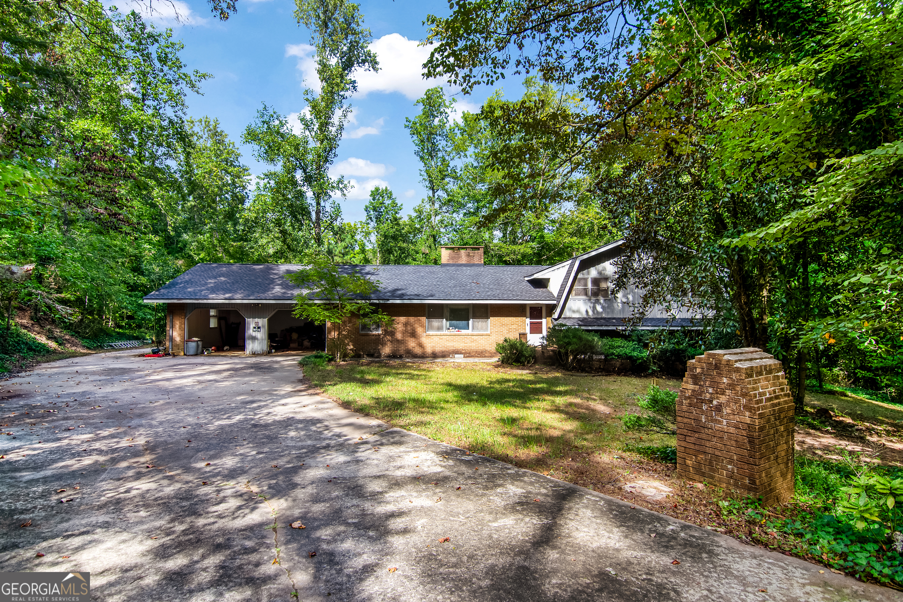 a front view of a house with a yard garage and outdoor seating