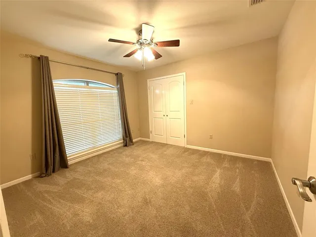 a view of an empty room and a window