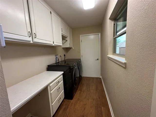 a kitchen with a sink a stove and cabinets