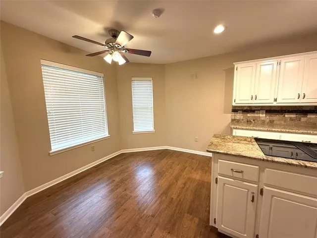 a view of a kitchen with a sink cabinets and wooden floor