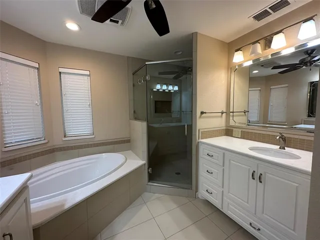 a bathroom with a bathtub sink and mirror