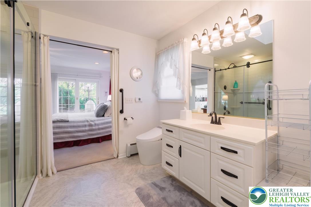 1089 Deemer Road Bath, PA 18014 - Photo 22 of 57 This bathroom features a sleek vanity, modern fixtures, and a bright, inviting ambiance.