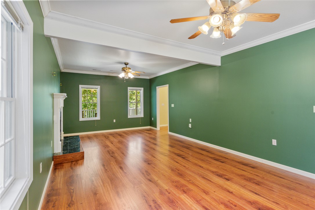 621 Burns Mill Road West Union, SC 29696 - Photo 6 of 45 Rich hardwood floors complement a classic fireplace and overhead lighting in this inviting living space.