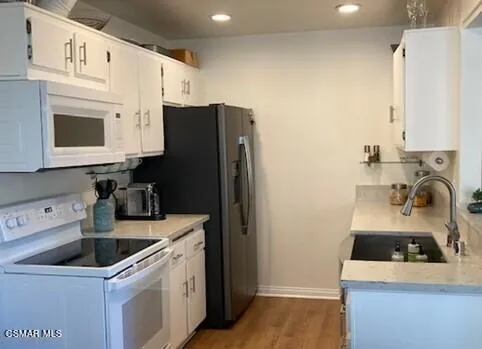 a kitchen with a sink a stove and refrigerator