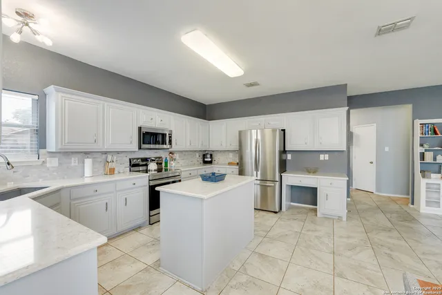 a kitchen with a sink a counter top space and appliances