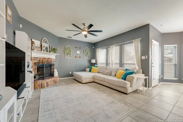 a living room with furniture flat screen tv and a fireplace
