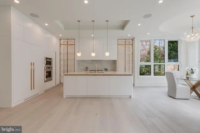 a view of kitchen with stainless steel appliances granite countertop cabinets and wooden floor