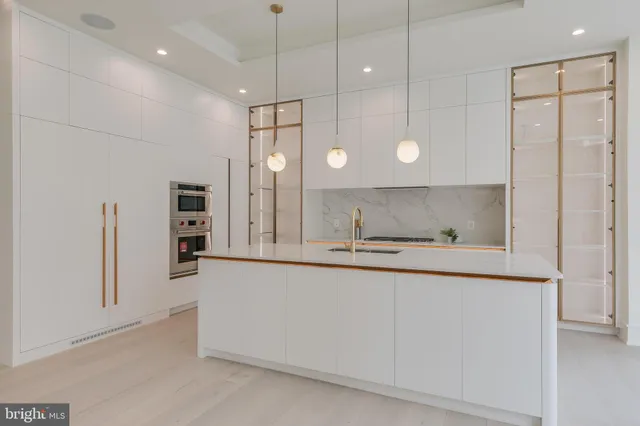 a view of a kitchen with a sink and a refrigerator