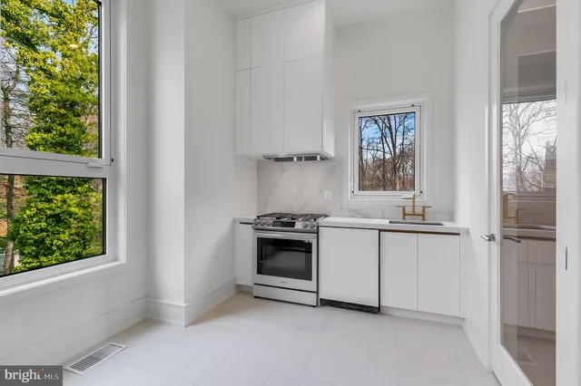 a kitchen with a stove and a refrigerator