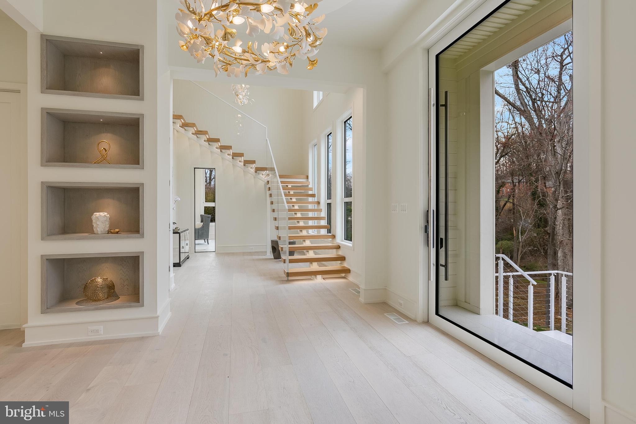8757 Brook Road McLean, VA 22102 - Photo 4 of 51 a view of a hallway with wooden floor and a front door