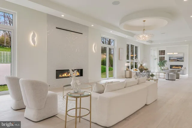 a living room with furniture and a chandelier