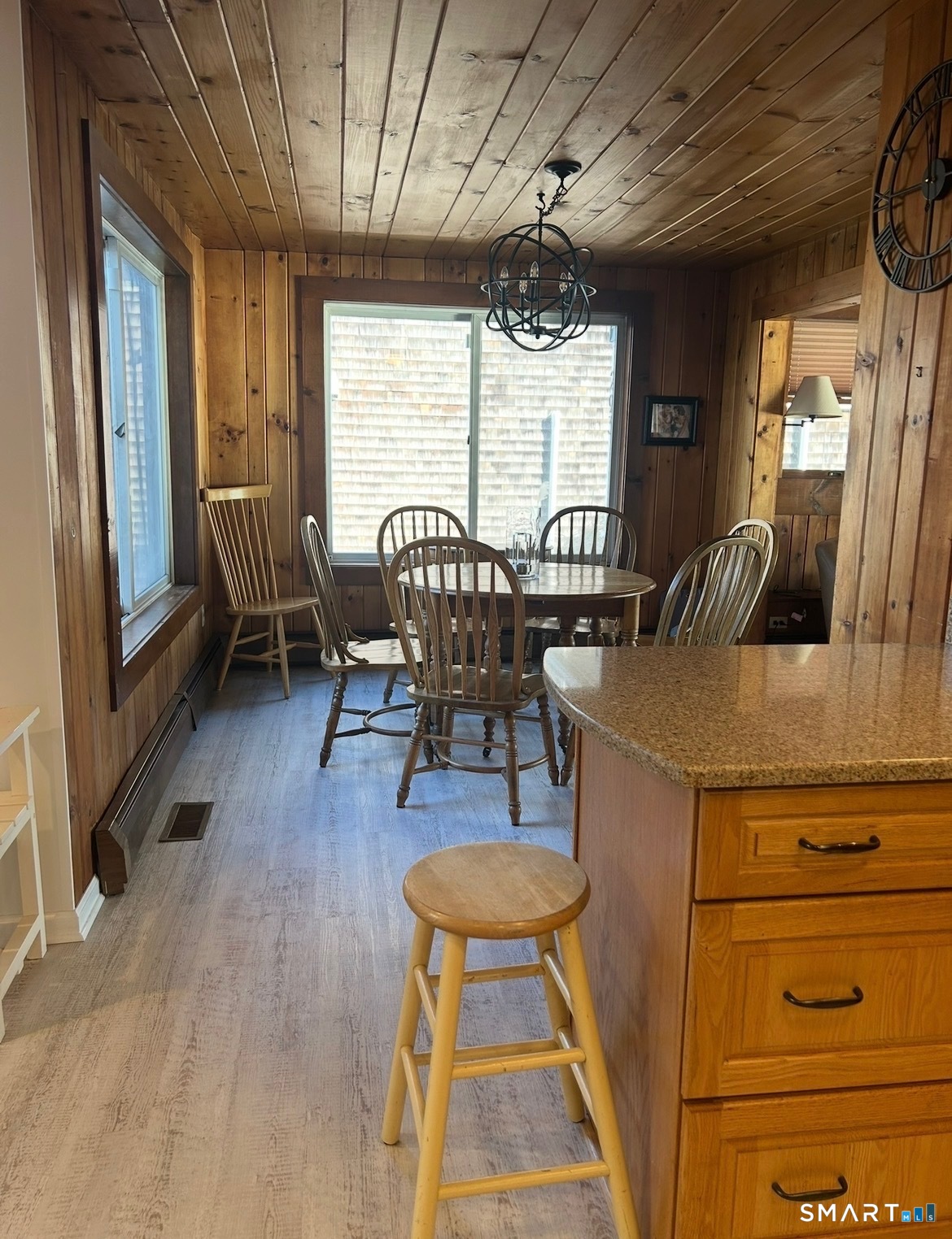 293 Giants Neck Road East Lyme, CT 06357 - Photo 6 of 21 a dining room with furniture a chandelier and wooden floor