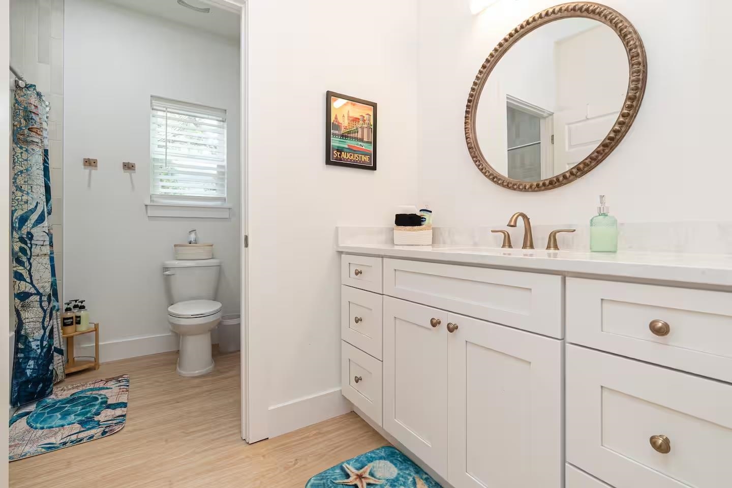 600 Twenty-First Street St. Augustine, FL 32084 - Photo 16 of 32 a bathroom with a toilet a sink and a mirror
