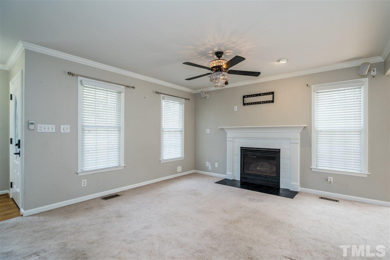 501 Woodland Road Raleigh, NC 27603 - Photo 7 of 28 an empty room with windows and fireplace