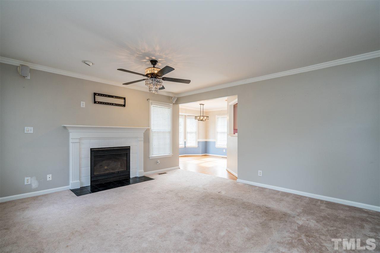 501 Woodland Road Raleigh, NC 27603 - Photo 9 of 28 a view of empty room with a fireplace and fan