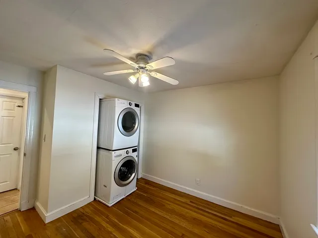 a view of a livingroom with wooden floor and cabinets