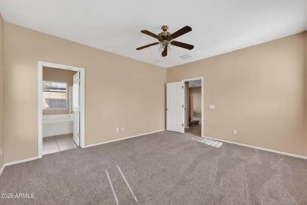 a view of a livingroom with a ceiling fan and window
