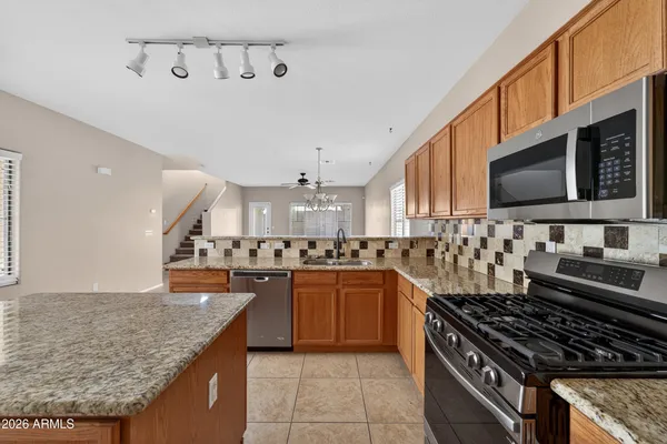 a kitchen with stainless steel appliances granite countertop a stove and a sink