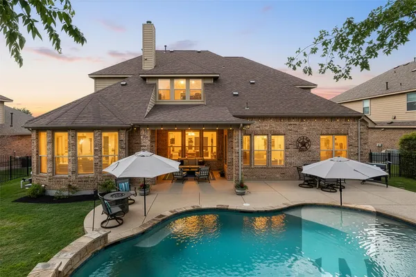 a front view of a house with swimming pool and porch