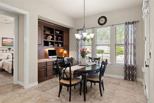 a kitchen with stainless steel appliances granite countertop wooden cabinets a stove top oven a sink and a large window