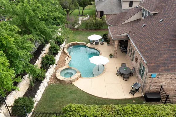 an aerial view of a house with outdoor space