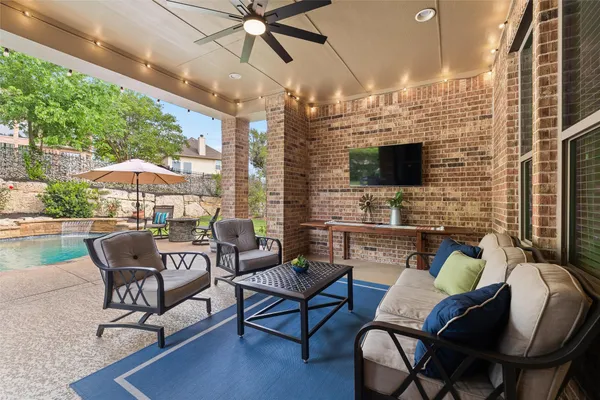 a outdoor living space with furniture and a flat screen tv