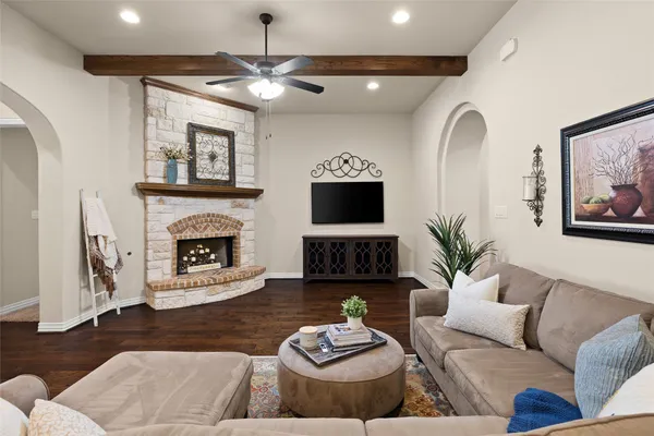 a living room with furniture a fireplace and a flat screen tv